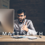 Frustrated man staring at computer — represents the moment before a porn relapse triggered by urges or mental lies.